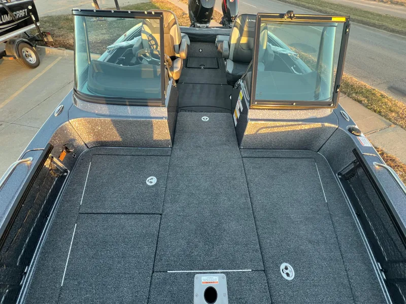 Slide: The Image of 2025 Lund 219 Pro-V GL boat interior with open compartments and seating. - 10