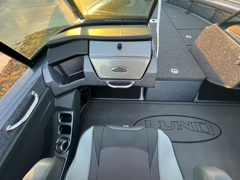 Slide: The Image of Interior of 2025 Lund 219 Pro-V GL boat, featuring sleek seating and storage compartments. - 3