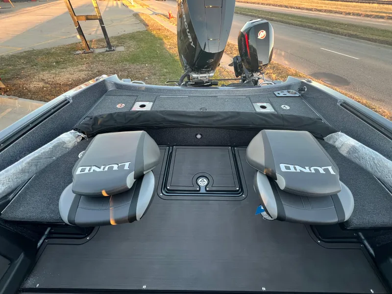 Slide: The Image of 2025 Lund 219 Pro-V GL boat interior with dual seats and motor view. - 4