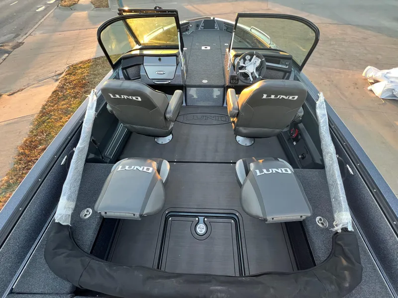 Slide: The Image of 2025 Lund 219 Pro-V GL boat interior with four seats and open windshield. - 5