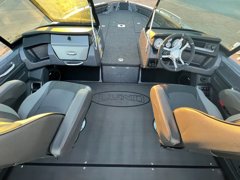 Slide: The Image of 2025 Lund 219 Pro-V GL boat interior with dual seats and steering console. - 8