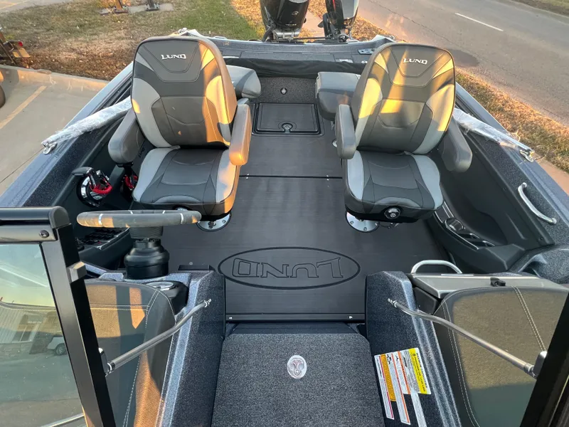 Slide: The Image of 2025 Lund 219 Pro-V GL boat interior with two seats and steering console. - 9