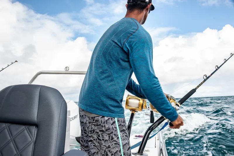 Slide: The Image of Person fishing on 2023 Axopar 28 T-Top boat in open sea. - 11