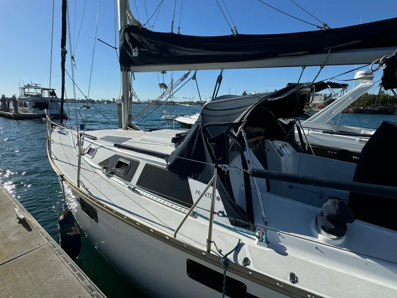 Slide: The Image of 1992 Hunter 35 sailboat docked at marina on a sunny day. - 11