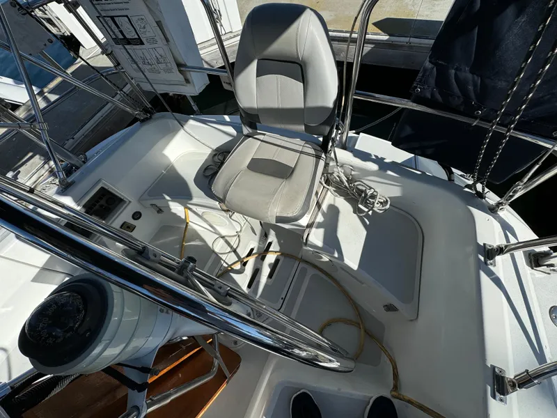 Slide: The Image of Cockpit of 1992 Hunter 35 sailboat with steering wheel and cushioned seat. - 19