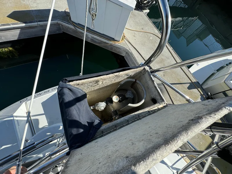 Slide: The Image of Sailboat deck with open compartment, Hunter 35, 1992 model, docked at marina. - 22