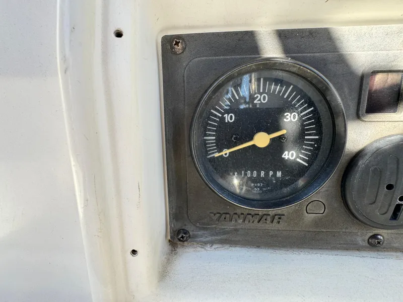 Slide: The Image of Yanmar RPM gauge on a 1992 Hunter 35 boat dashboard. - 25