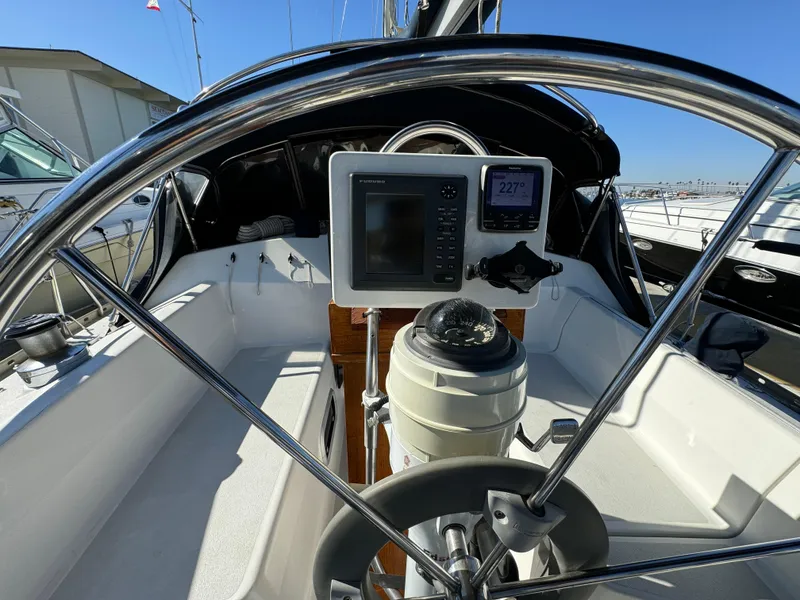 Slide: The Image of 1992 Hunter 35 sailboat cockpit with steering wheel and navigation instruments. - 27