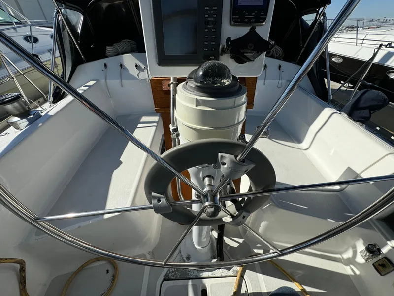 Slide: The Image of Cockpit of a 1992 Hunter 35 sailboat with steering wheel and navigation equipment. - 28