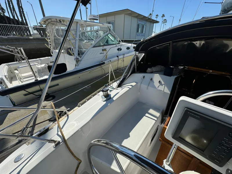 Slide: The Image of Cockpit view of a 1992 Hunter 35 sailboat docked at a marina. - 31