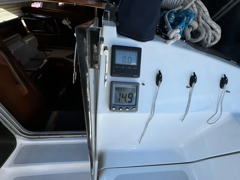 Slide: The Image of Interior view of a 1992 Hunter 35 sailboat cockpit with navigation instruments. - 33
