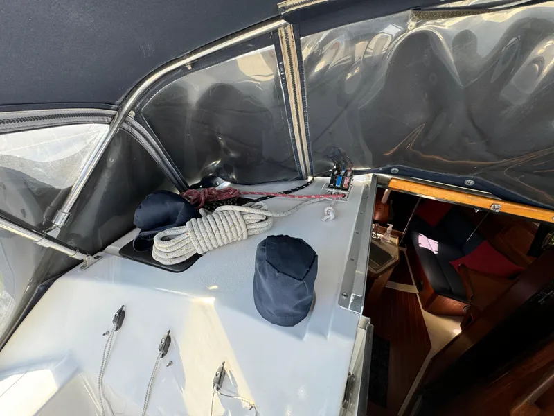 Slide: The Image of 1992 Hunter 35 sailboat cockpit with ropes and covered equipment, interior view visible. - 36