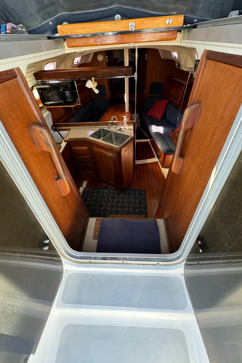 Slide: The Image of Interior view of a 1992 Hunter 35 sailboat, featuring a cozy cabin with wooden finishes. - 37