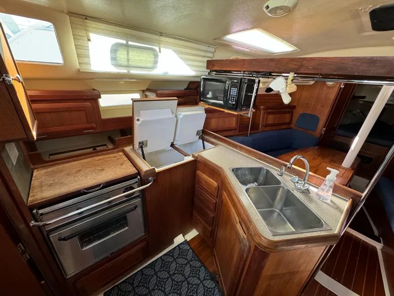 Slide: The Image of Interior of a 1992 Hunter 35 sailboat with kitchen and seating area. - 39