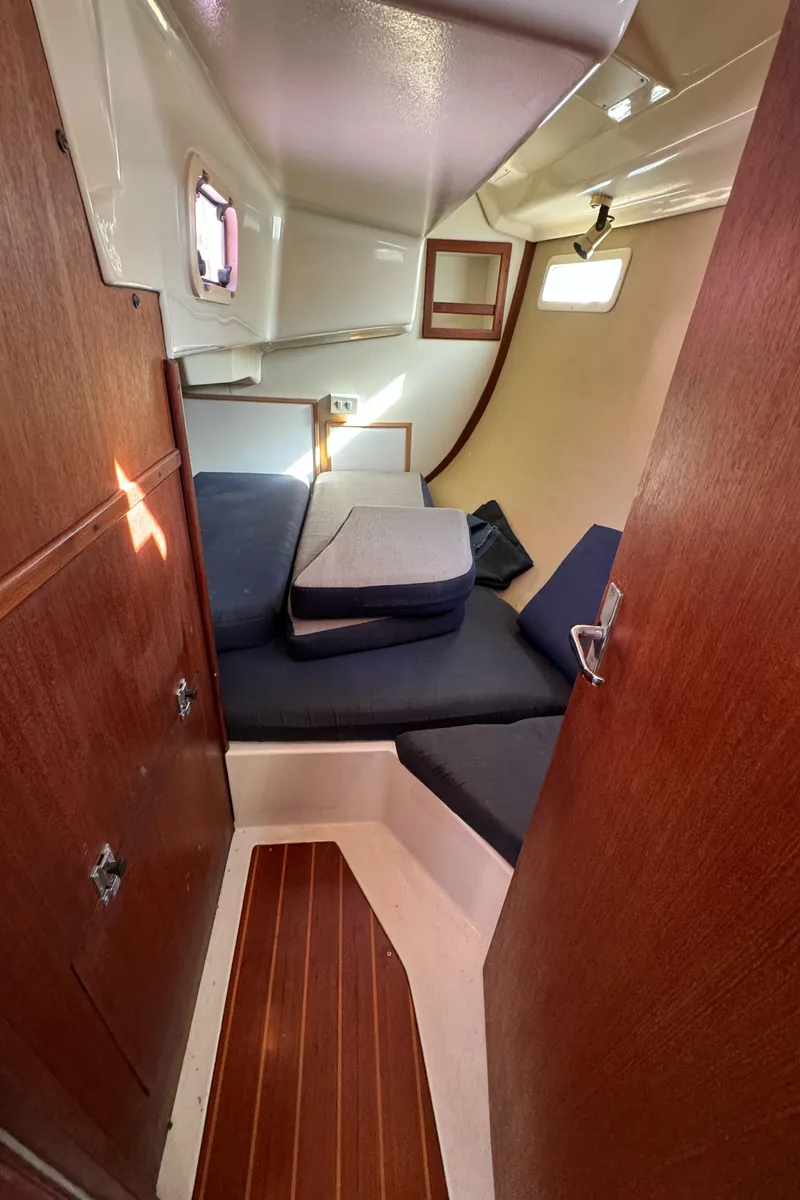 Slide: The Image of Cozy cabin interior of 1992 Hunter 35 sailboat with wooden finishes and cushions. - 47