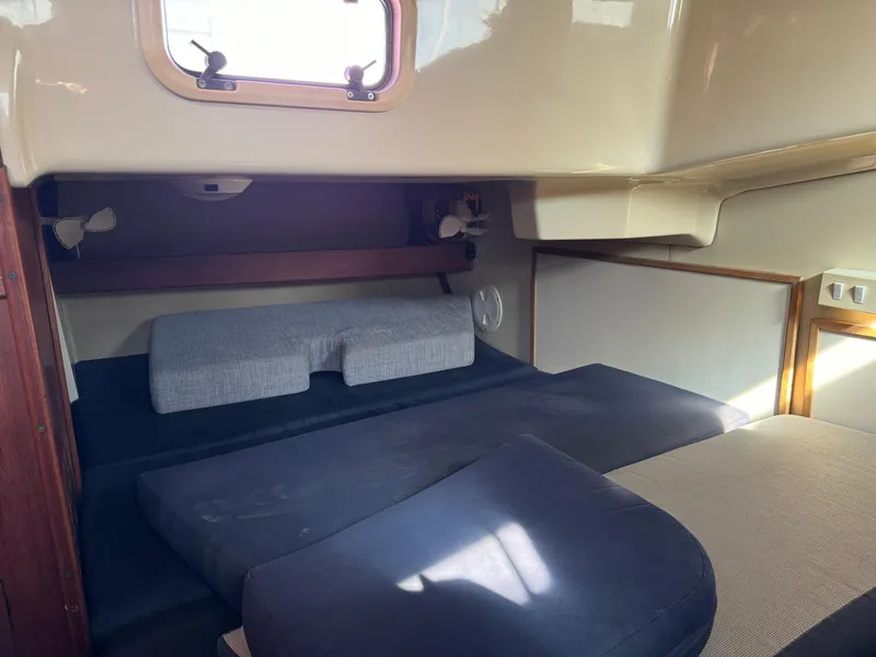 Slide: The Image of Interior cabin of a 1992 Hunter 35 sailboat with cushioned seating. - 49