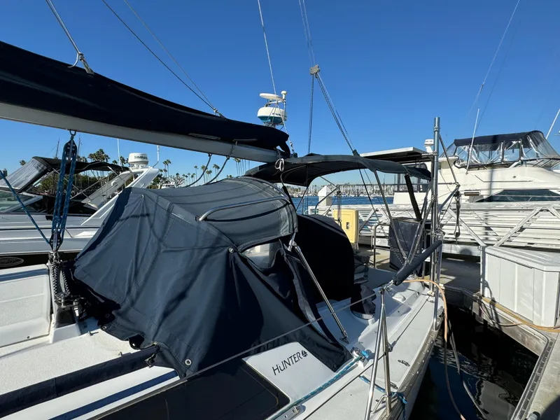 Slide: The Image of 1992 Hunter 35 sailboat docked at marina under clear blue sky. - 6