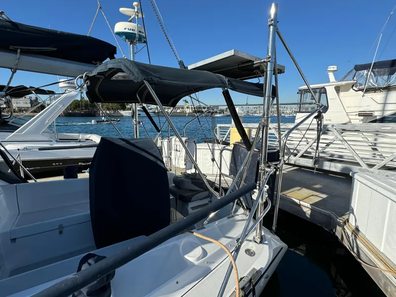 Slide: The Image of 1992 Hunter 35 sailboat docked at marina, featuring blue canopy and clear sky. - 7