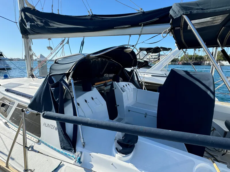 Slide: The Image of Sailboat Hunter 35, 1992 model, docked with blue canopy and clear sky background. - 9