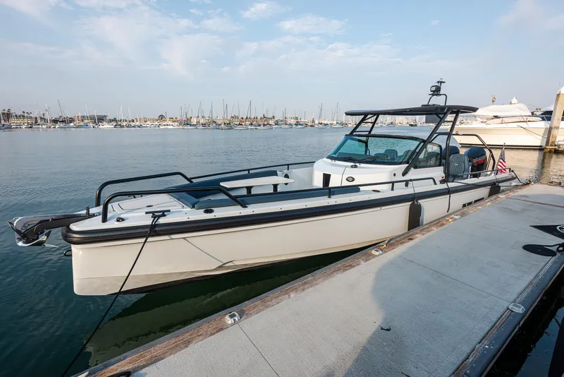 Slide: The Image of 2023 BRABUS Shadow 500 T-Top AFT Cabin boat docked in marina. - 2