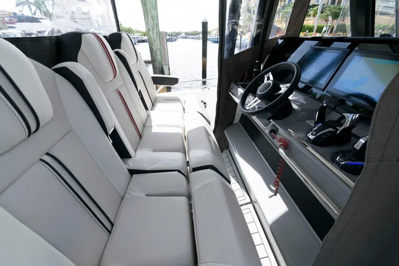Slide: The Image of 2023 Jeanneau Leader 10.5 CC cockpit with modern seating and navigation controls. - 16