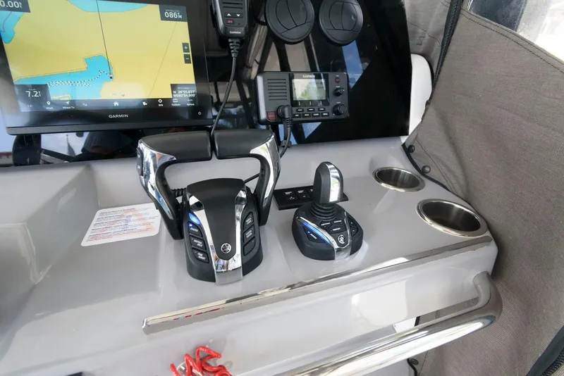 Slide: The Image of 2023 Jeanneau Leader 10.5 CC helm with navigation controls and display screen. - 18