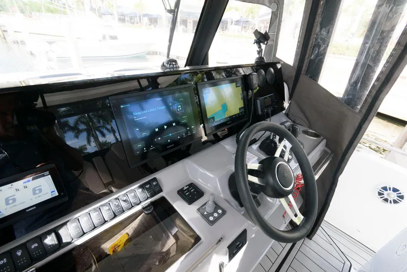 Slide: The Image of 2023 Jeanneau Leader 10.5 CC cockpit with modern navigation displays and steering wheel. - 19