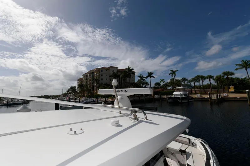 Slide: The Image of 2023 Jeanneau Leader 10.5 CC boat docked at marina under blue sky. - 23