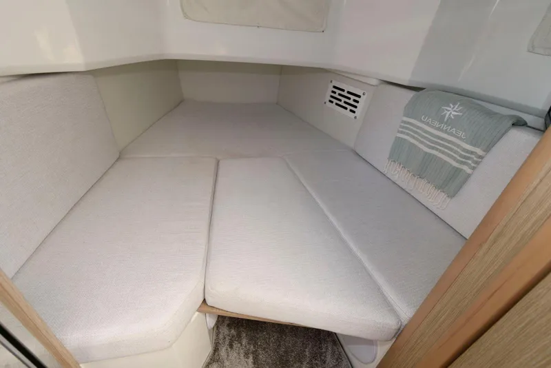 Slide: The Image of 2023 Jeanneau Leader 10.5 CC cabin interior with cozy seating and soft cushions. - 26