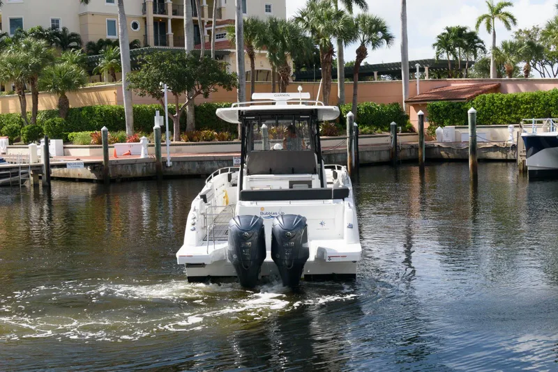 Slide: The Image of 2023 Jeanneau Leader 10.5 CC boat docked in a marina with twin engines. - 4