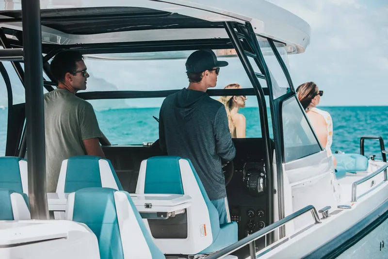 Slide: The Image of People enjoying a ride on a 2023 Axopar 37 Sun-Top Wet Bar boat. - 12