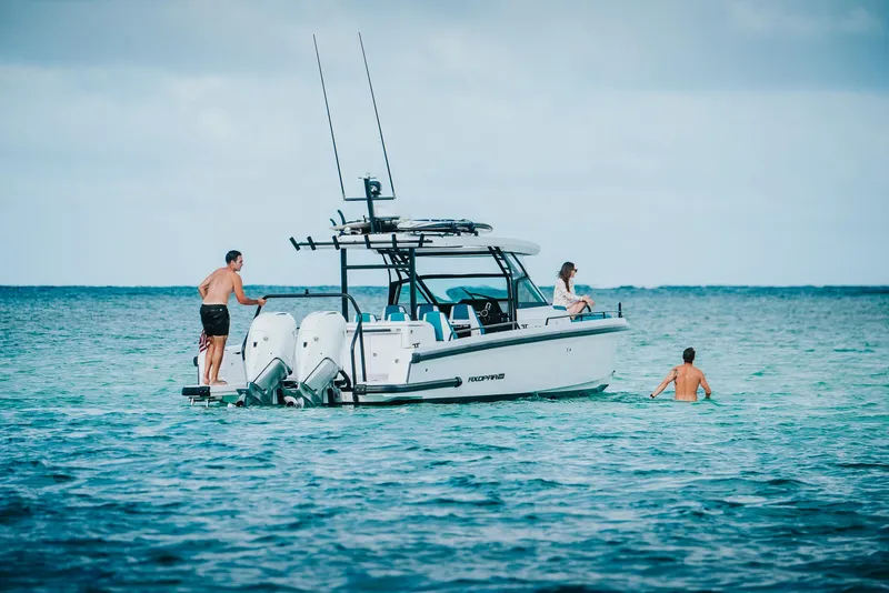 Slide: The Image of 2023 Axopar 37 Sun-Top Wet Bar boat with people enjoying the ocean. - 18