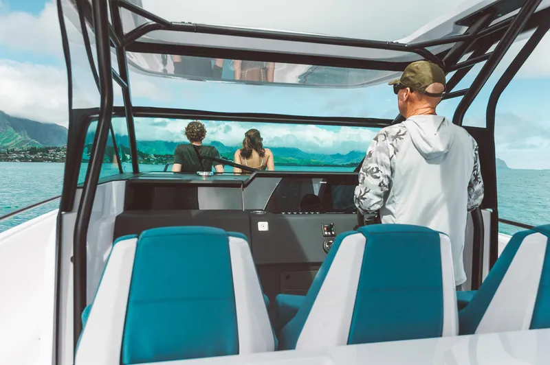 Slide: The Image of 2023 Axopar 37 Sun-Top Wet Bar cruising with passengers enjoying scenic ocean views. - 21