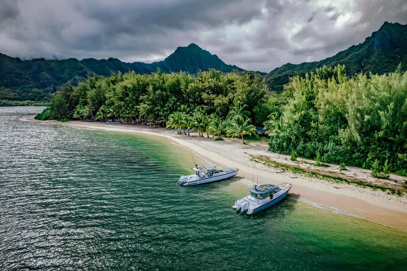 Slide: The Image of Two Axopar 37 Sun-Top Wet Bar boats on a tropical beach, 2023 model. - 23