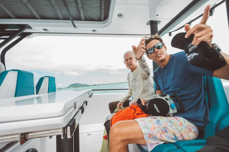 Slide: The Image of Two people enjoying a ride on a 2023 Axopar 37 Sun-Top Wet Bar boat. - 9