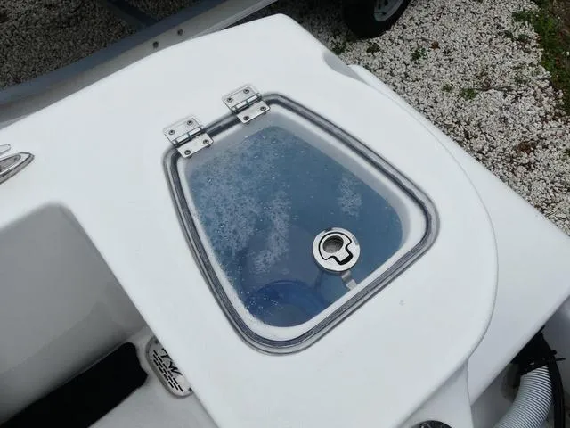 Slide: The Image of 2023 Tidewater 210 CC Adventure boat livewell with clear lid and latch. - 12