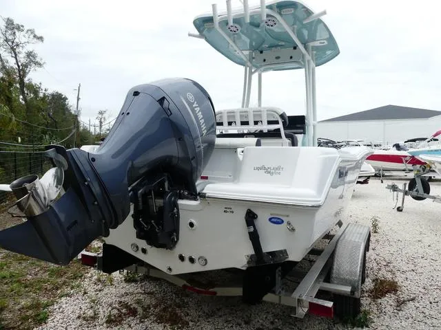 Slide: The Image of 2023 Tidewater 210 CC Adventure boat with Yamaha outboard motor on a trailer. - 5
