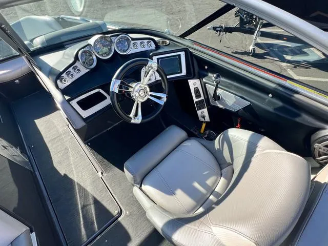 Slide: The Image of 2012 MasterCraft X25 boat cockpit with modern controls and steering wheel. - 11