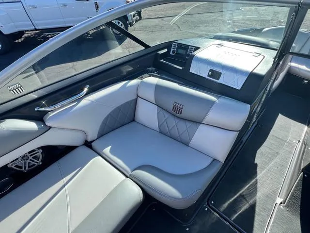 Slide: The Image of 2012 MasterCraft X25 boat interior with gray and white seating. - 12