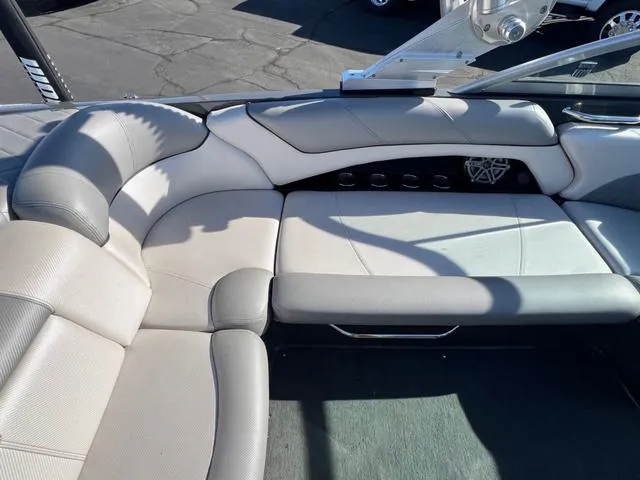 Slide: The Image of 2012 MasterCraft X25 boat interior with gray seating and cup holders. - 13