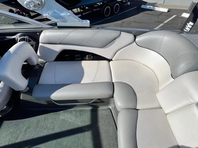 Slide: The Image of 2012 MasterCraft X25 boat interior with gray seating and cup holders. - 15