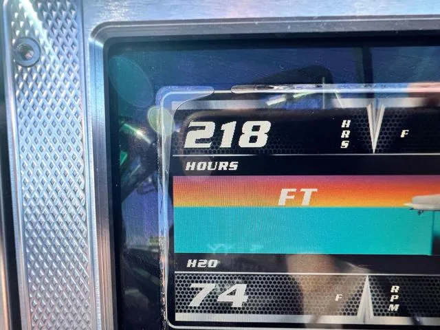Slide: The Image of Close-up of a 2012 MasterCraft X25 dashboard showing 218 hours and 74 RPM. - 18