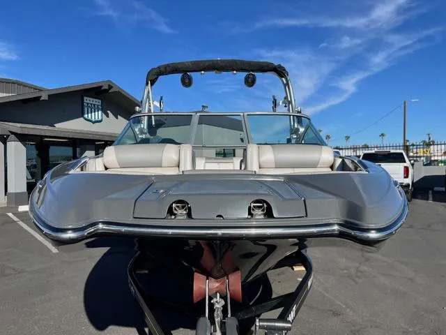 Slide: The Image of 2012 MasterCraft X25 boat in a parking lot under a clear blue sky. - 3