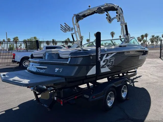Slide: The Image of 2012 MasterCraft X25 boat on trailer, parked outdoors, sunny day. - 5