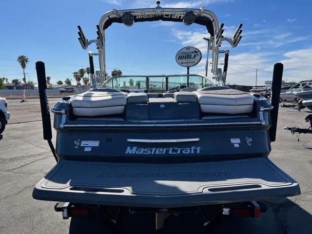 Slide: The Image of 2012 MasterCraft X25 boat with wakeboard tower, rear view in sunny marina. - 6