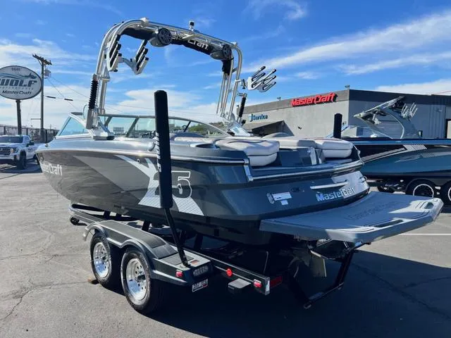 Slide: The Image of 2012 MasterCraft X25 boat on trailer, parked outdoors at dealership. - 7