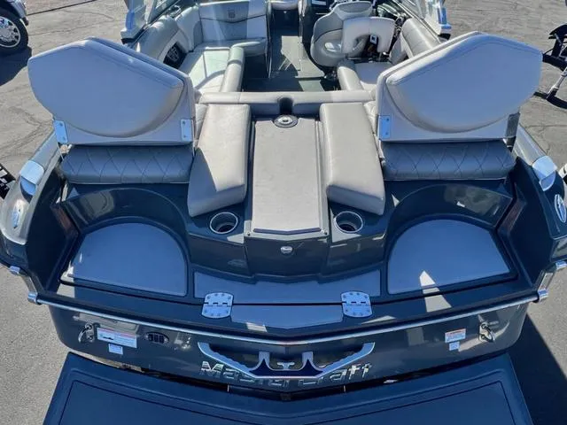 Slide: The Image of 2012 MasterCraft X25 boat interior with gray seating and cup holders. - 9