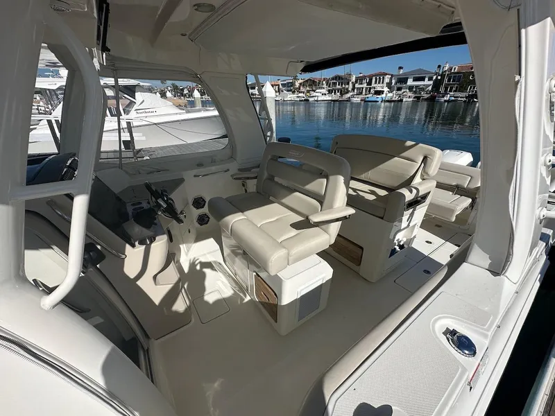 Slide: The Image of Interior of 2019 Boston Whaler 350 Realm boat with beige seating and helm. - 12