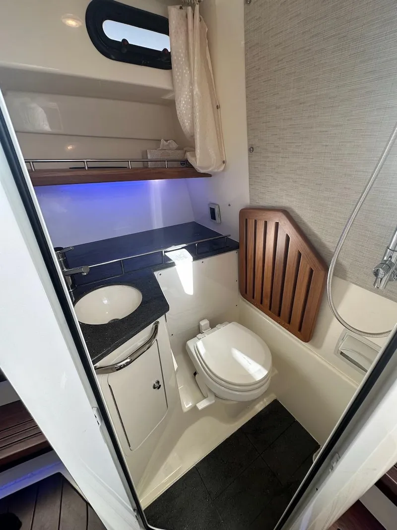 Slide: The Image of 2019 Boston Whaler 350 Realm bathroom with sink, toilet, and shower. - 26