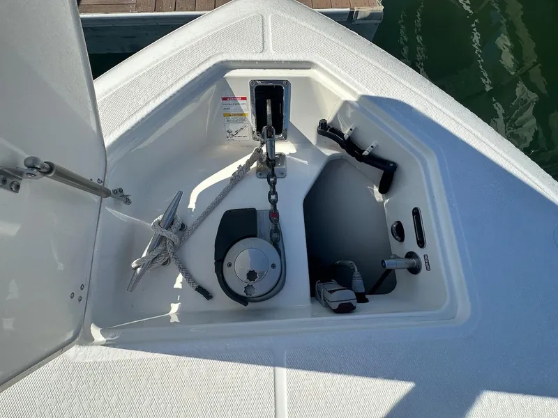 Slide: The Image of Anchor compartment of 2019 Boston Whaler 350 Realm boat, featuring rope and winch. - 28